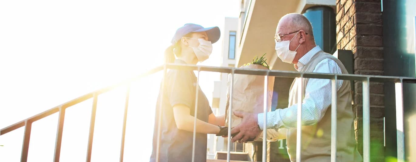 People wearing masks delivering groceries