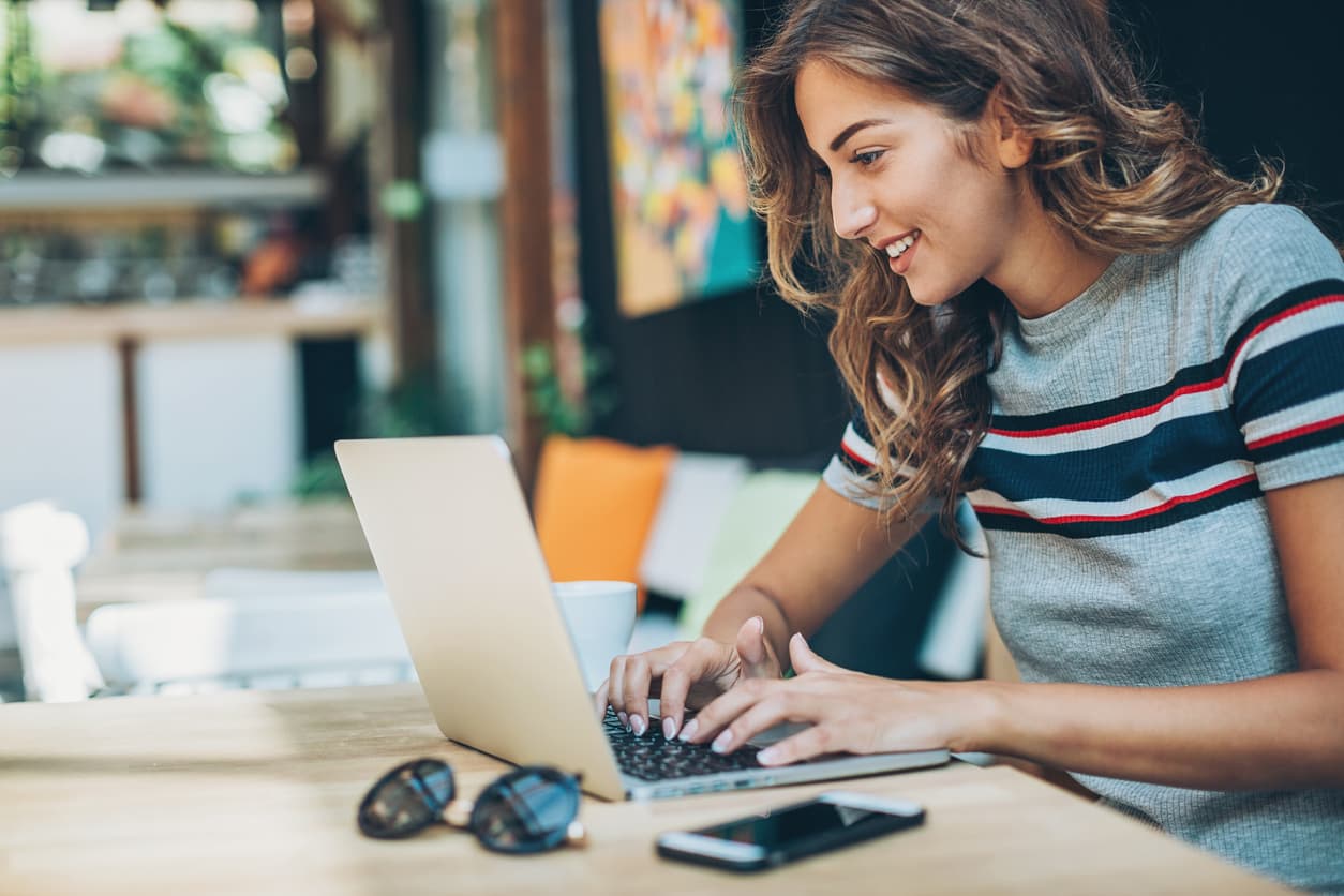 Twenty something young woman looking up information on laptop