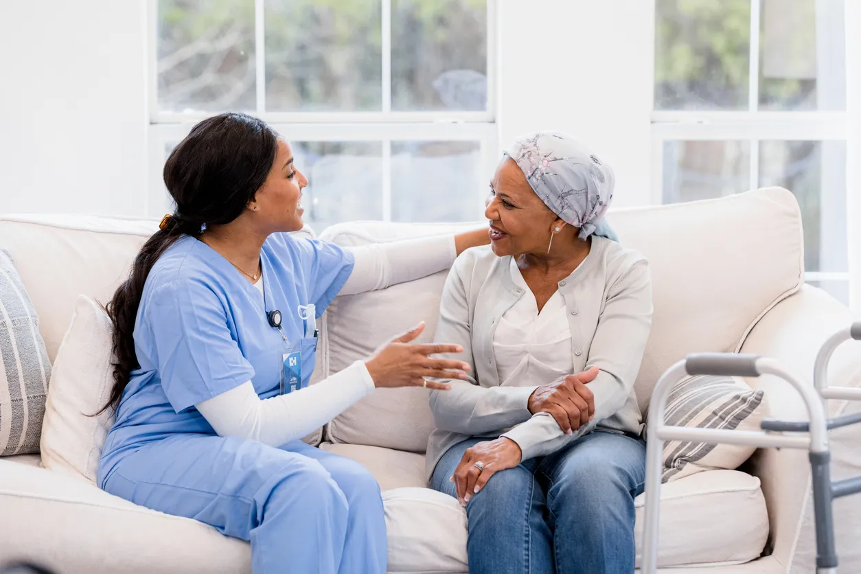 Nurse with patient on sofa