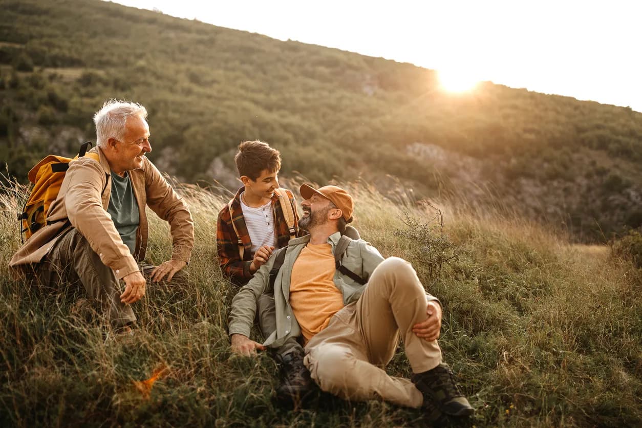 Three men resting during a hike
