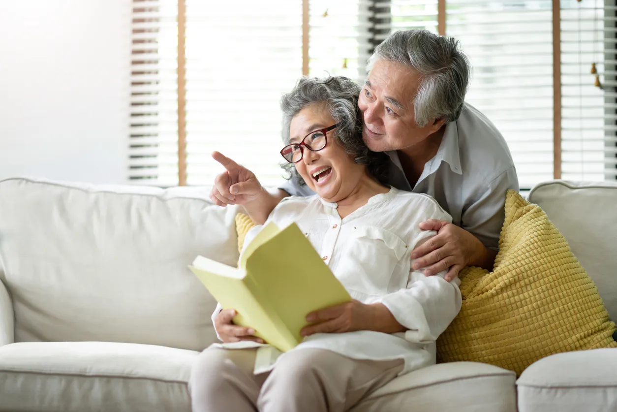 A couple looking at something and smiling
