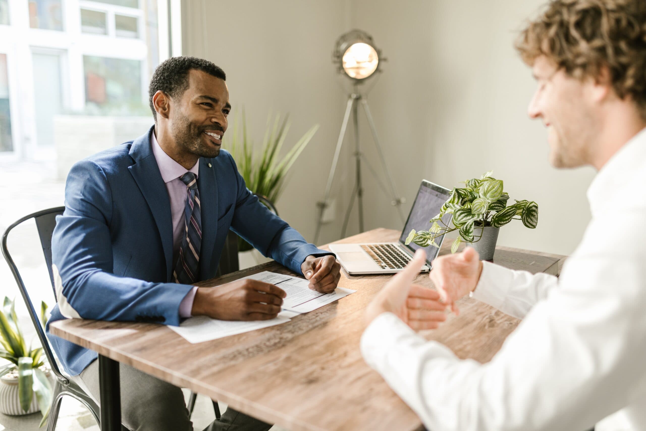 Businessman talking to a man across a table