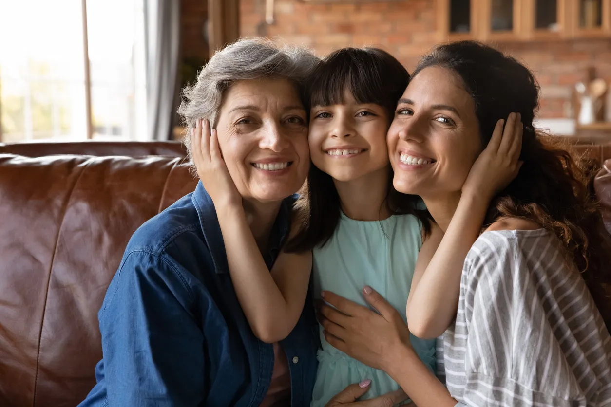 Girl with two other women on a sofa