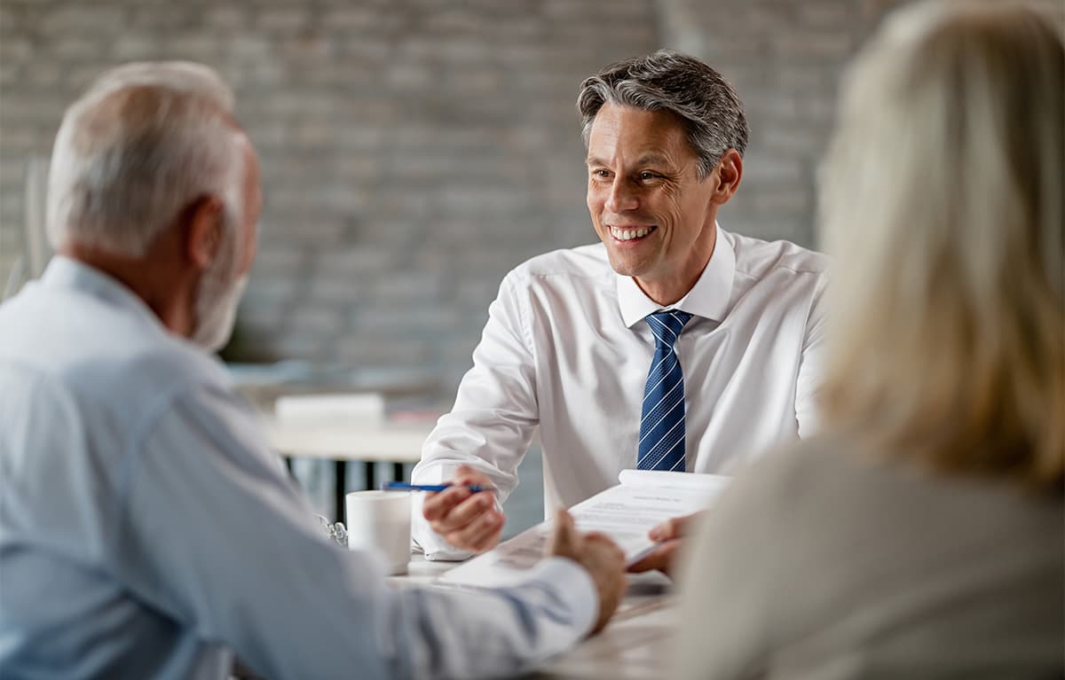 Male agent discussing to a couple about insurance