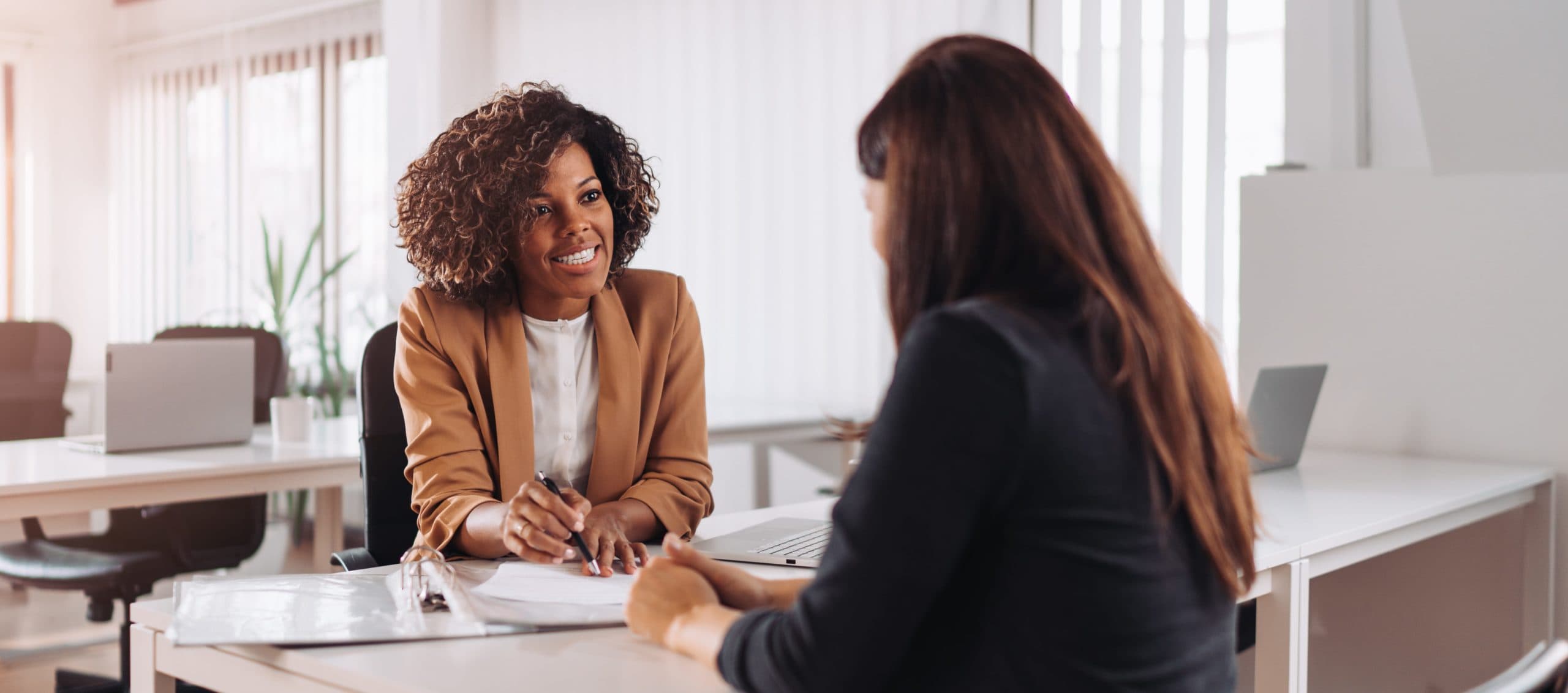 Young lady agent assisting a woman